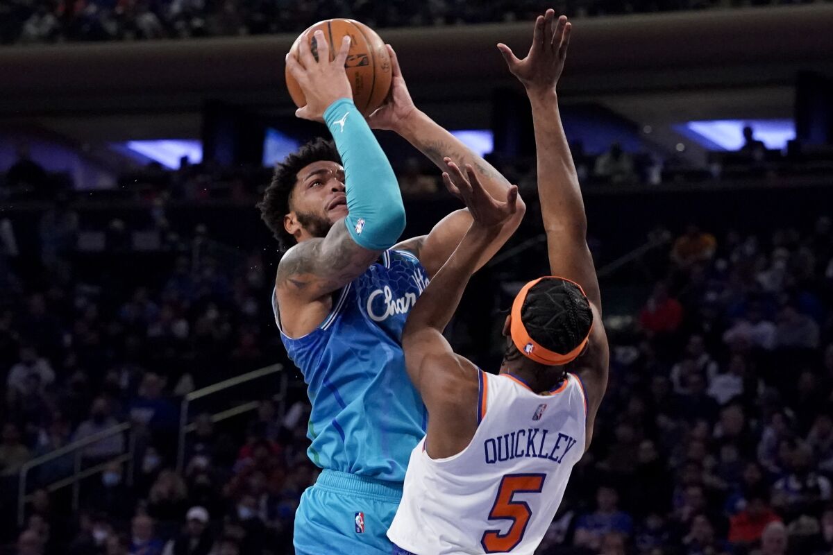 Charlotte Hornets forward Miles Bridges (0) shoots against New York Knicks guard Immanuel Quickley (5) during the first half of an NBA basketball game, Monday, Jan. 17, 2022, in New York. (AP Photo/John Minchillo)