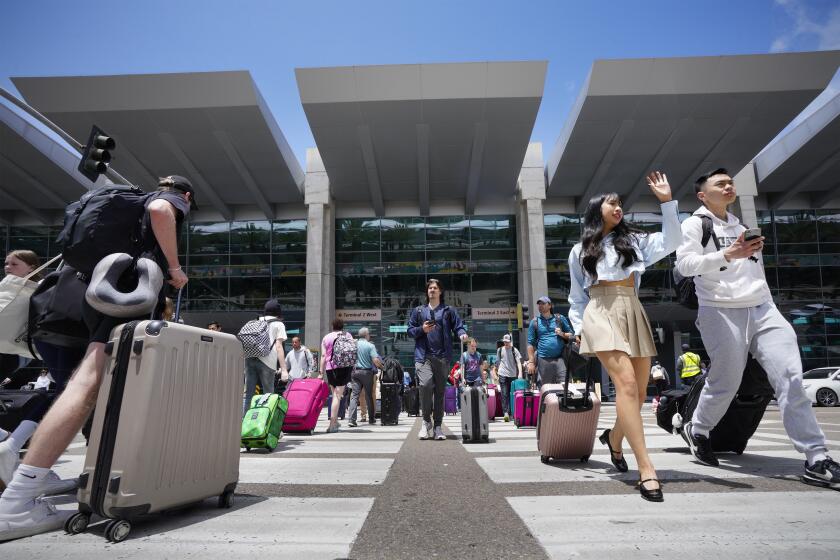 San Diego, CA - May 23: With the upcoming holiday weekend, the forecast predicts a record-setting number of people getting away by plane, car, train, and cruise ship. On Thursday, May 23, 2024, in San Diego, travelers arriving at San Diego International Airport make their way to ground transportation, while others make their way towards the terminal. (Nelvin C. Cepeda / The San Diego Union-Tribune)