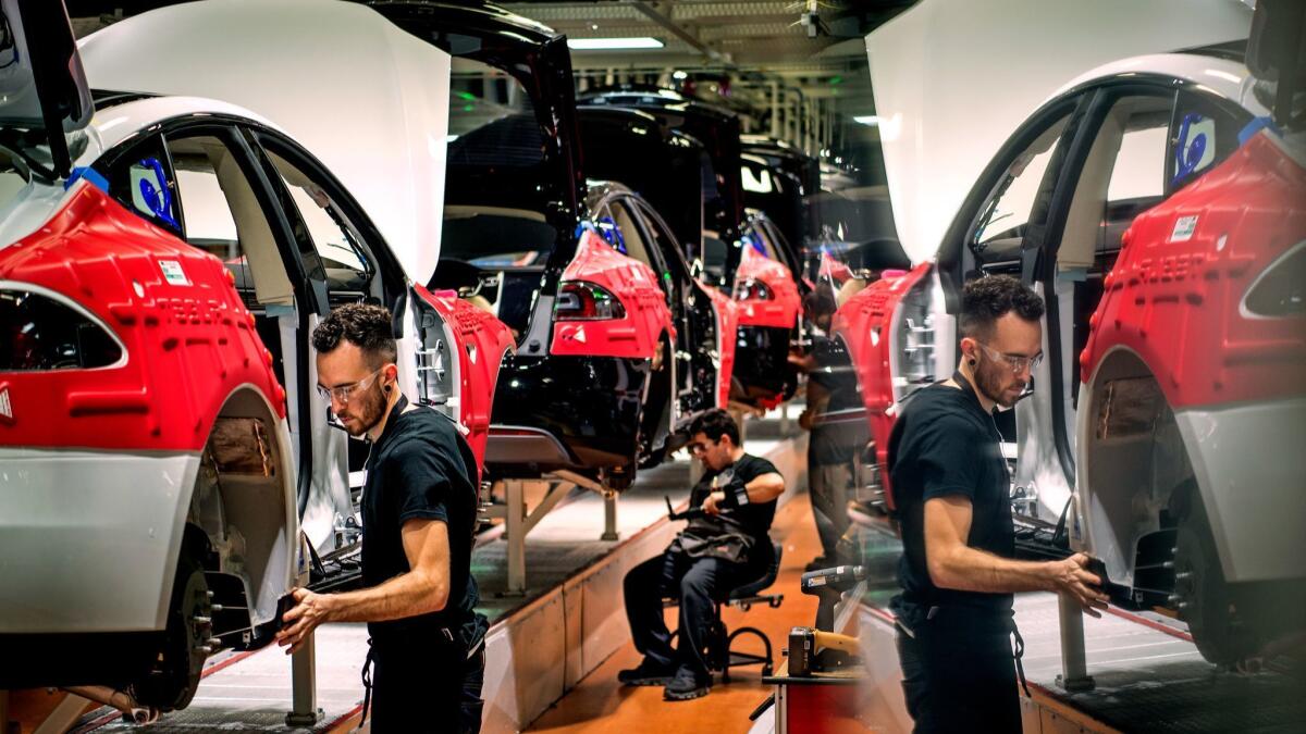 Workers assemble cars at Tesla's factory in Fremont, Calif. Until there is hard evidence of sustained progress on fixing the Model 3’s problems, Tesla relies on sheer investor belief.