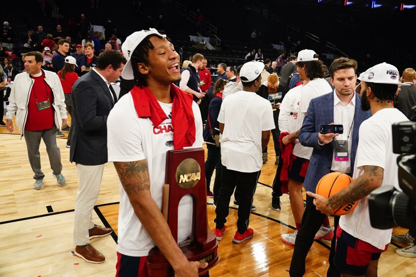 Florida Atlantic's Isaiah Gaines (5) holds the trophy as Florida Atlantic players celebrate after defeating Kansas State in an Elite 8 college basketball game in the NCAA Tournament's East Region final, Saturday, March 25, 2023, in New York. (AP Photo/Frank Franklin II)