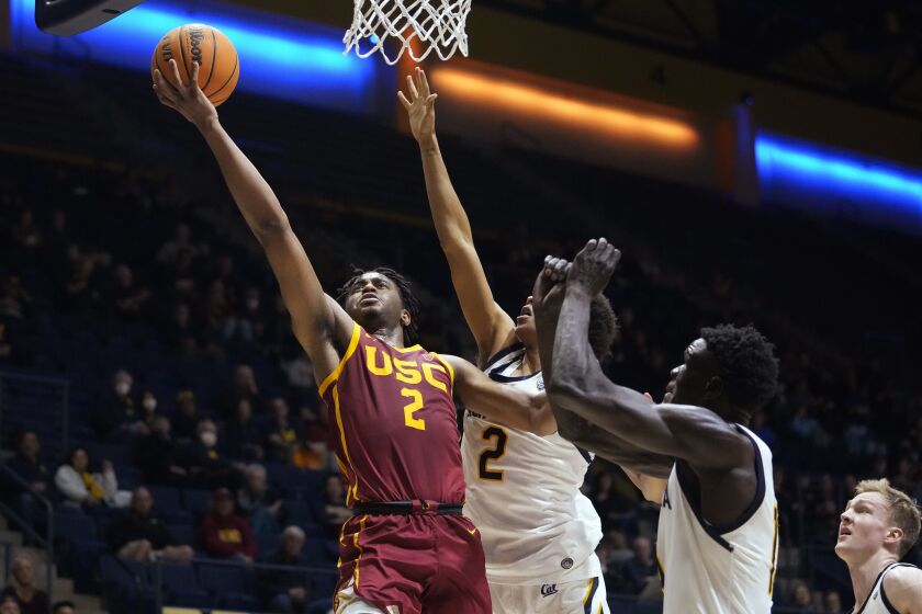 Southern California guard Reese Dixon-Waters (2) shoots while defended by California forward Monty Bowser (2) during the second half of an NCAA college basketball game in Berkeley, Calif., Wednesday, Nov. 30, 2022. (AP Photo/Godofredo A. Vásquez)