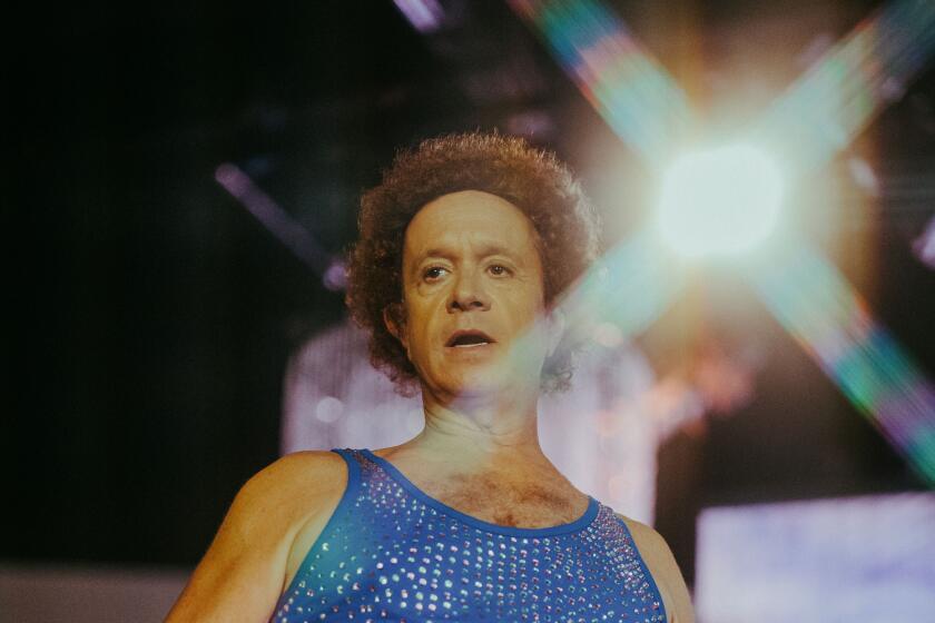 A man in a bedazzled blue tank top.