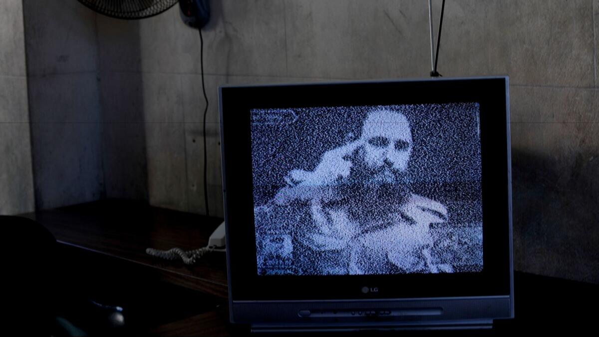 Footage of Fidel Castro plays on a television set outside of Havana after his death.