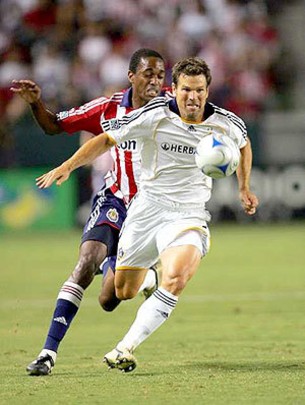 Galaxy defender Greg Vanney battles Chivas USA's Atiba Harris for possession in 2008.