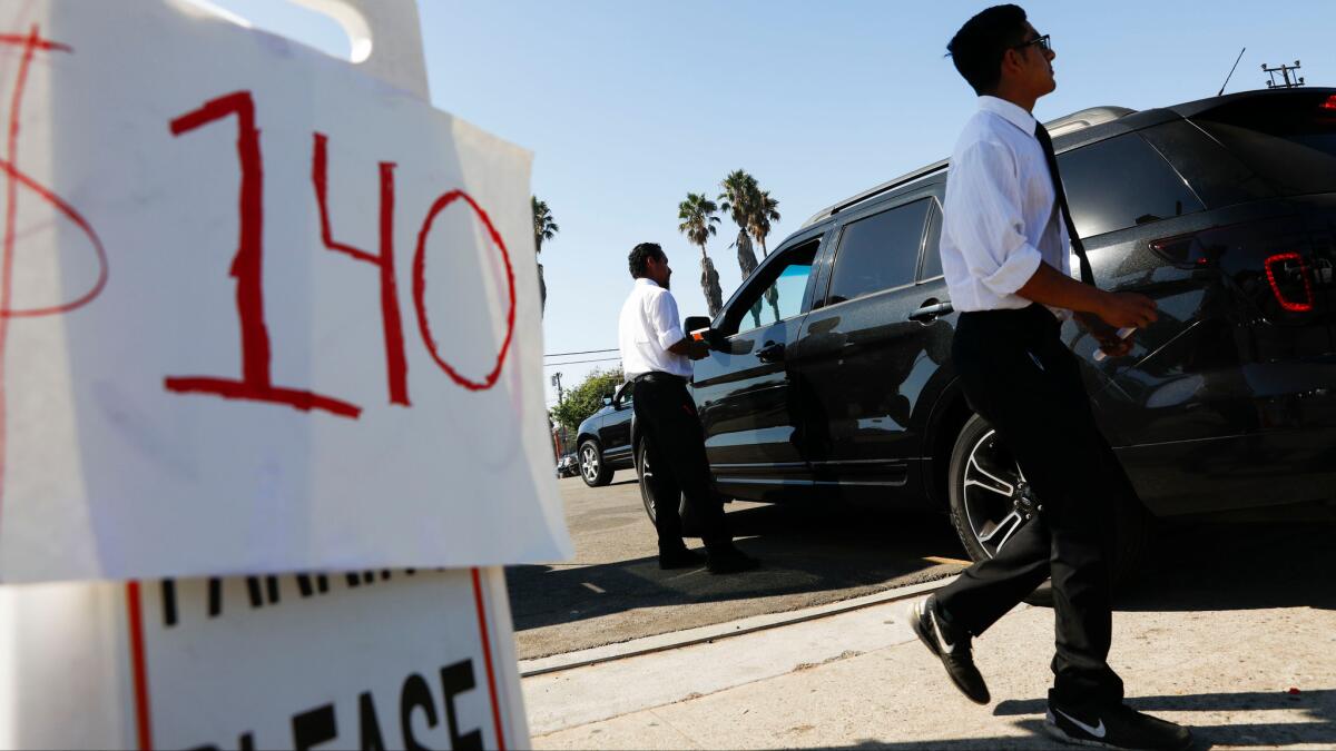 One lot sold parking spaces for $140 for Sunday's Rams-Seahawks game at the Coliseum.