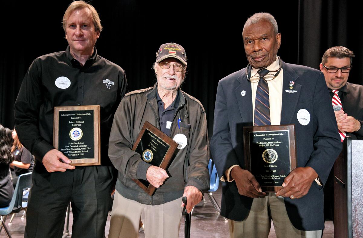 From left, Robert Gilliland Jr., who received a plaque for his father, Bob, who was a test pilot, U.S. Army retired veteran Dick Guyer and U.S. Air Force Maj. Frederick Lamar Stafford, retired, were honored Thursday at Wilson Middle School's annual Veterans Day Assembly. The older Gilliland, who passed away recently, was an SR-71 test pilot who still holds world records for flight.