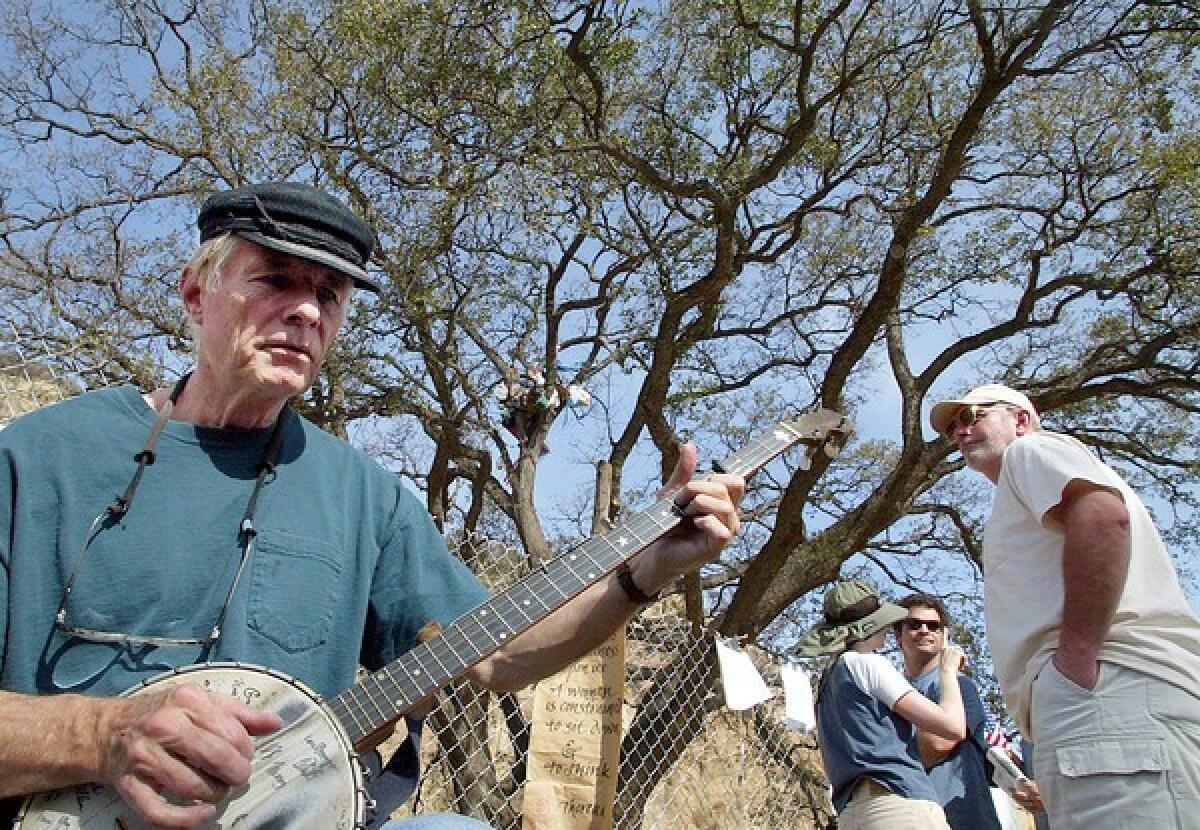 Fred Starner plays beneath a 400-year-old oak threatened with removal on the outskirts of Santa Clarita. While studying at Oberlin College in Ohio in the 1950s, Starner became interested in American folk music.
