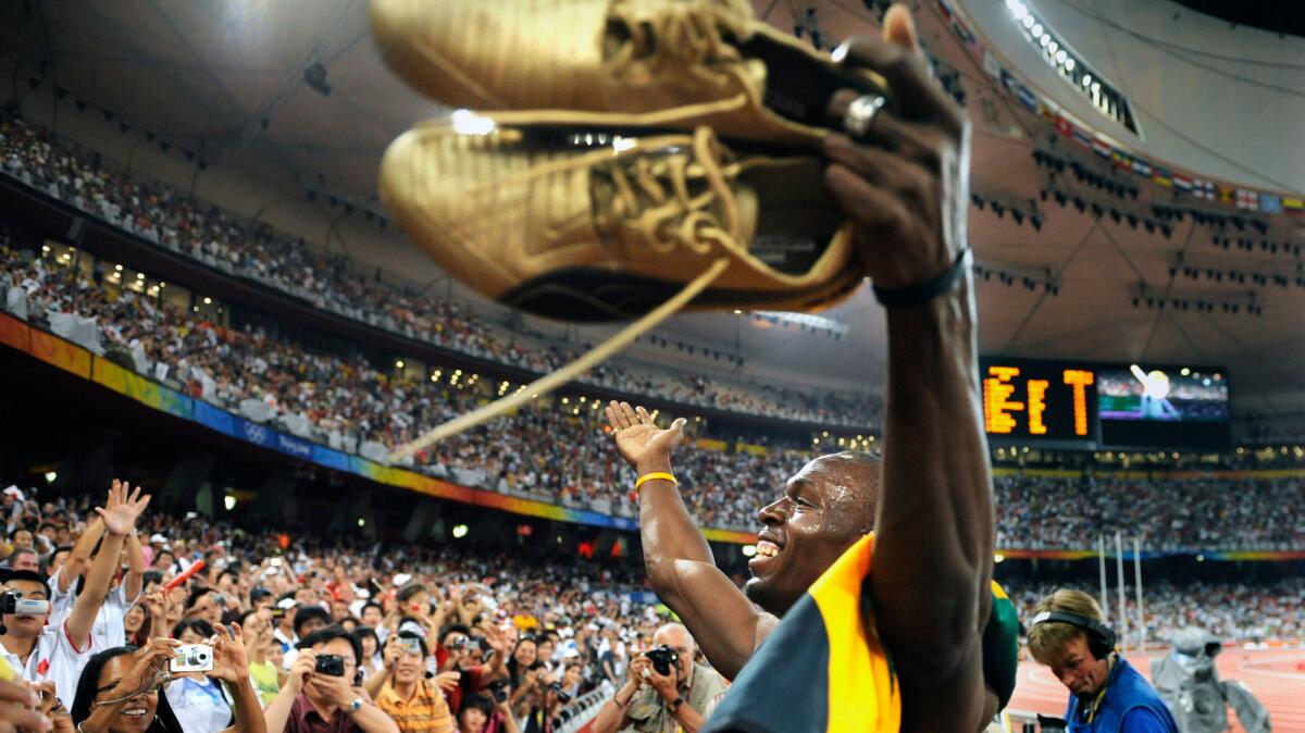 Usain Bolt celebrates after helping the Jamaican team win gold in the 400-meter relay at the 2008 Beijing Olympics.