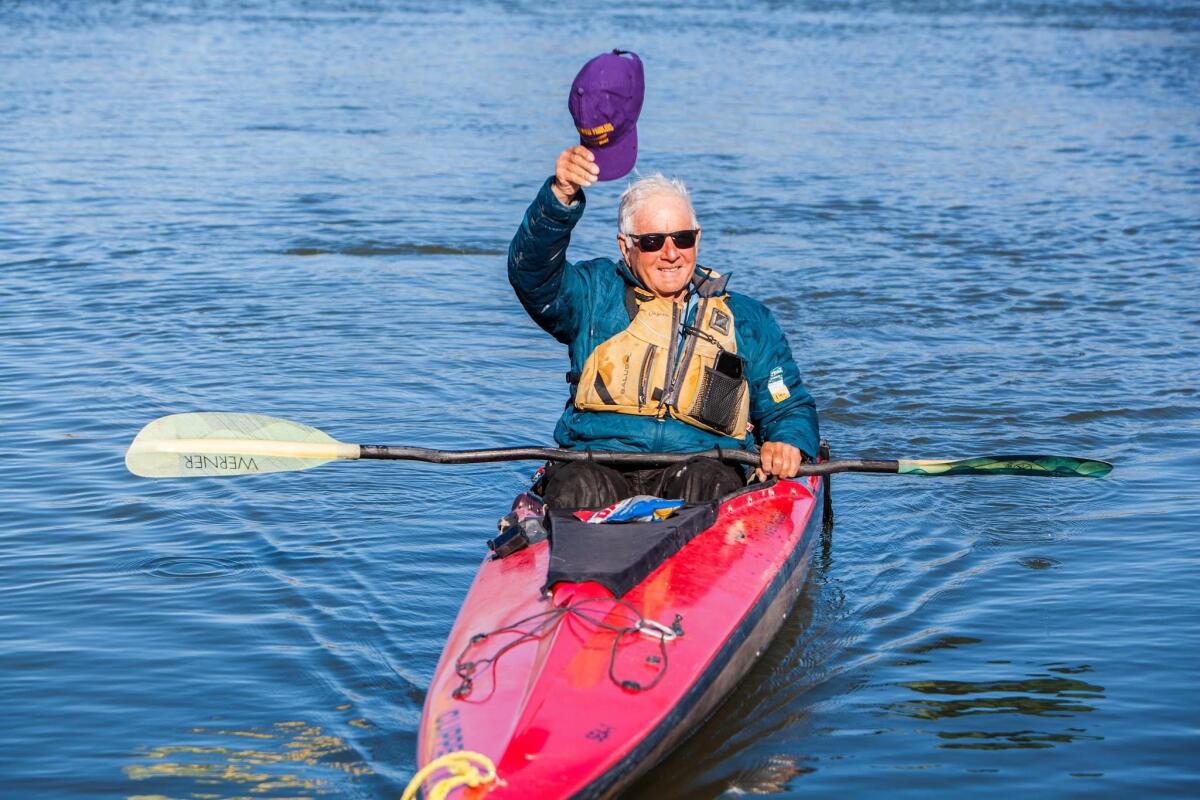 Bill Burke tips his cap on the Missouri River near New Haven, Mo.