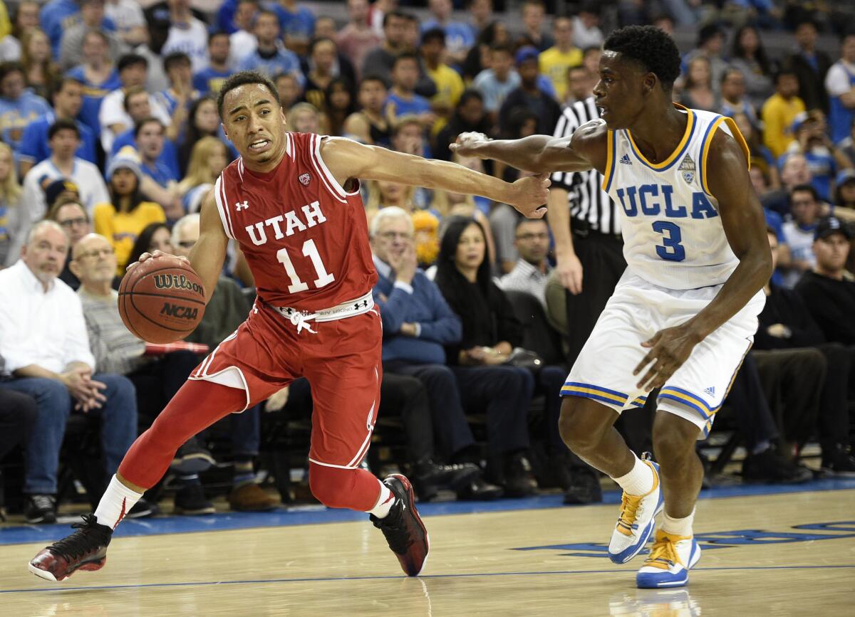 Utah guard Brandon Taylor (11) drives the baseline against UCLA guard Aaron Holiday (3) during the first half.