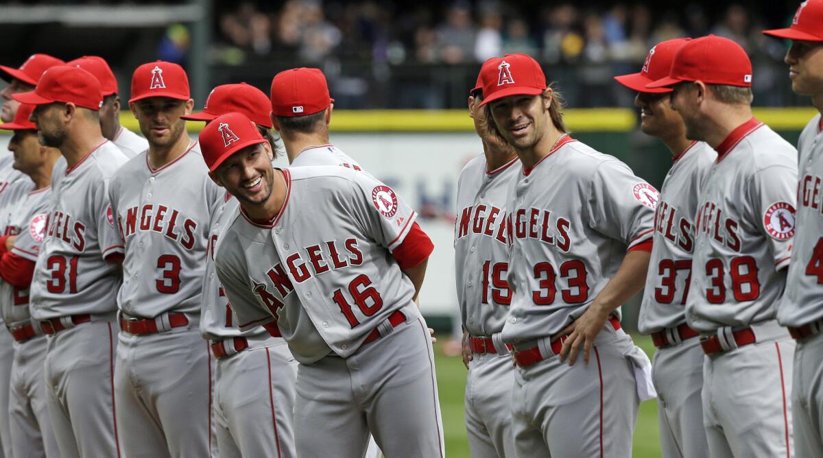 Huston Street (16) smiles as he looks down the line during team introductions before the Angels' season opener against the Mariners in Seattle.