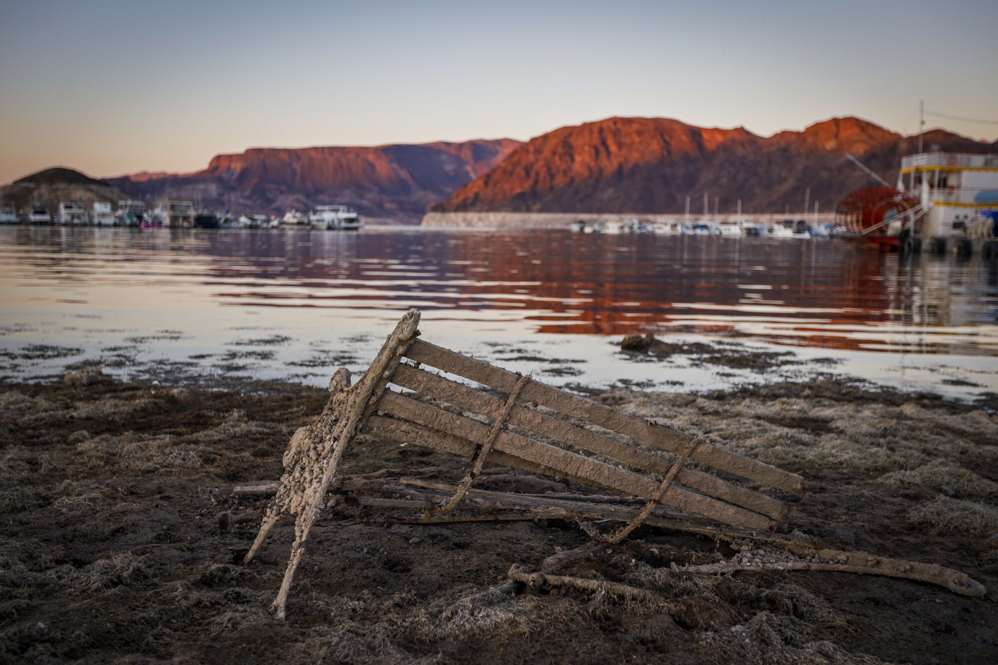 A formerly sunken bench rests on the shore near the Hemenway Harbor launch ramp on Lake Mead in Nevada.