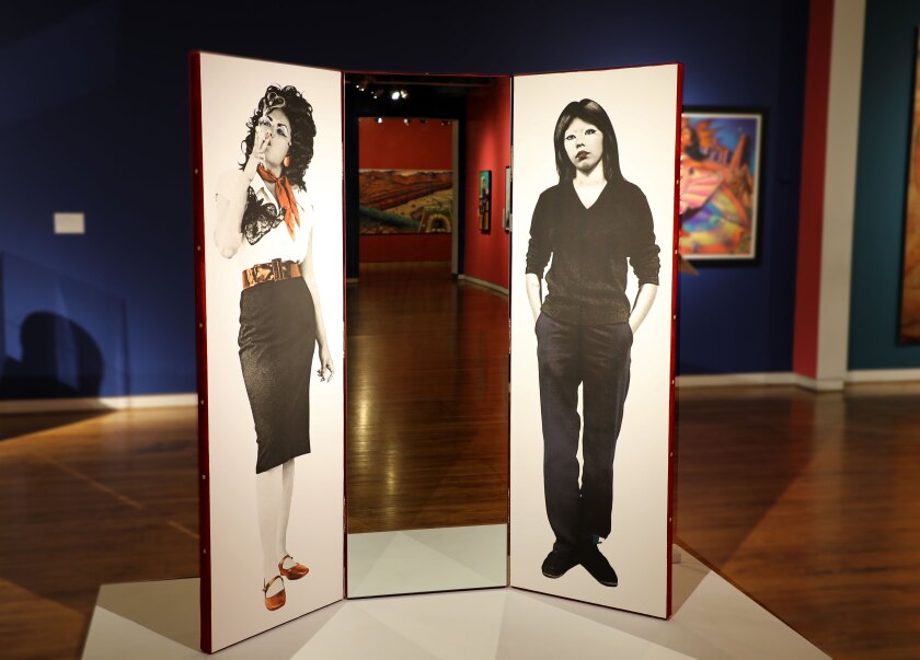 The triptych on a human scale features images of Pachuka and Chola adjacent to a mirror in which the viewer sees himself.
