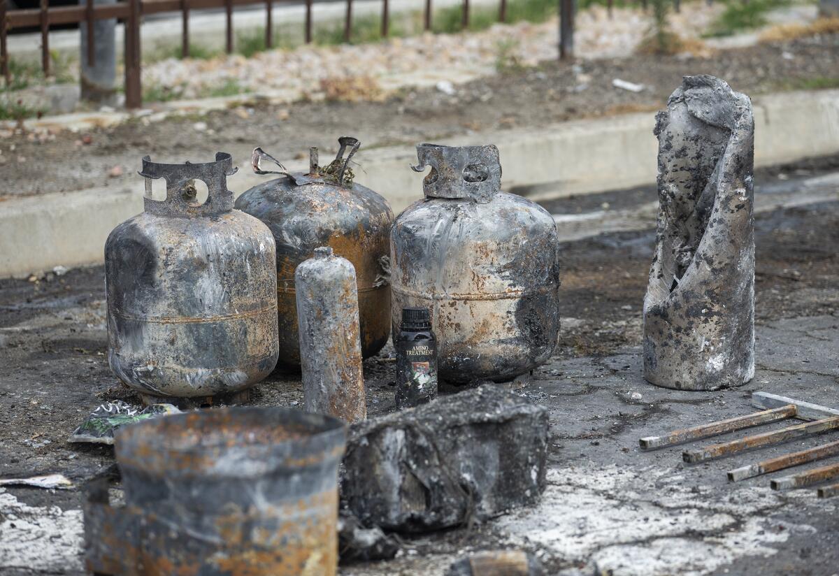 Propane tanks are part of the wreckage from a structure fire in Costa Mesa on Tuesday, June 2.