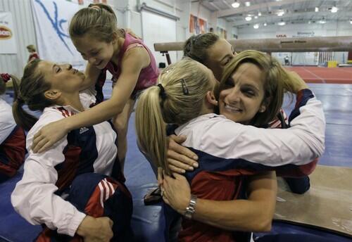 Mary Lou Retton, right, hugs Samantha Peszek during the final day of the U.S. selection camp as Retton's daughter McKennea Kelley hugs Alicia Sacramone. Both Peszek and Sacramone made the women's team.