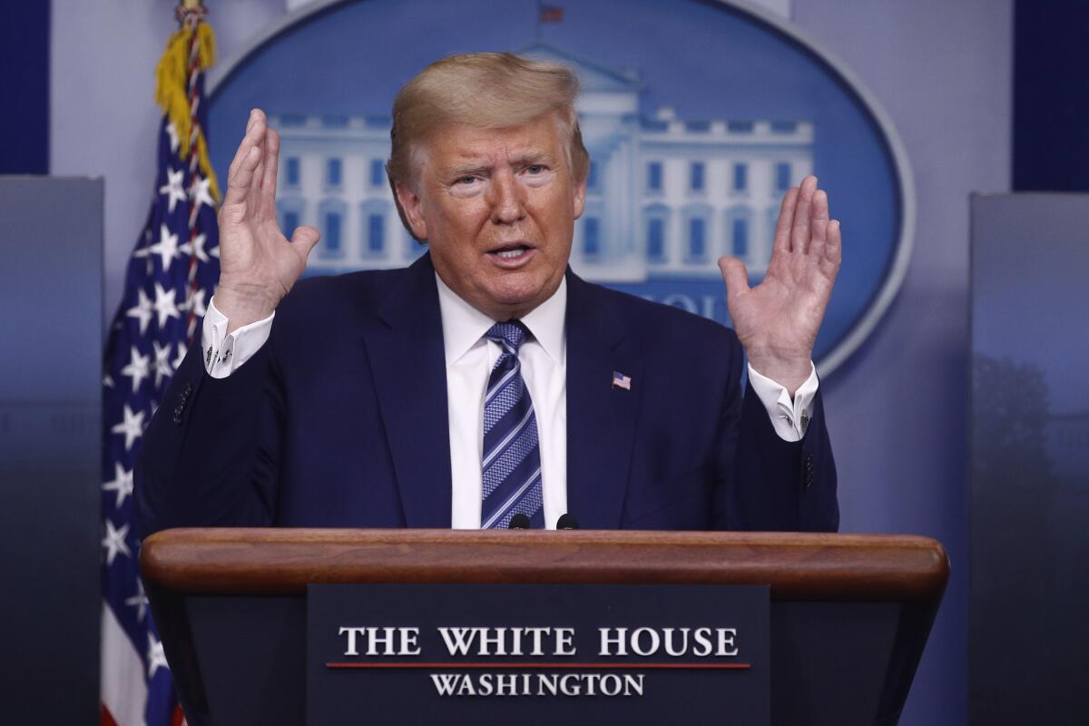 President Trump, shown speaks during a coronavirus task force briefing at the White House Sunday, has removed one inspector general and demoted the Pentagon's acting inspector general.