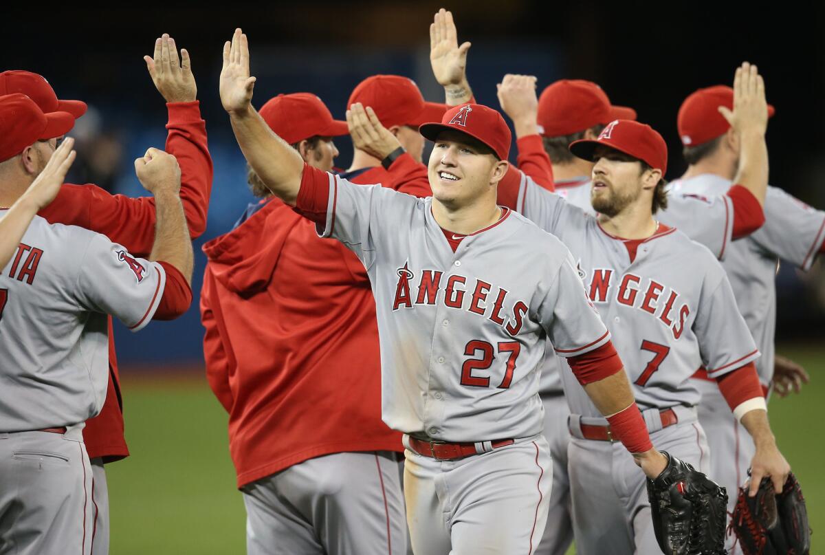 Angels outfielder Mike Trout (21) celebrates a 4-3 victory over the Toronto Blue Jays with his teammates on May 20.