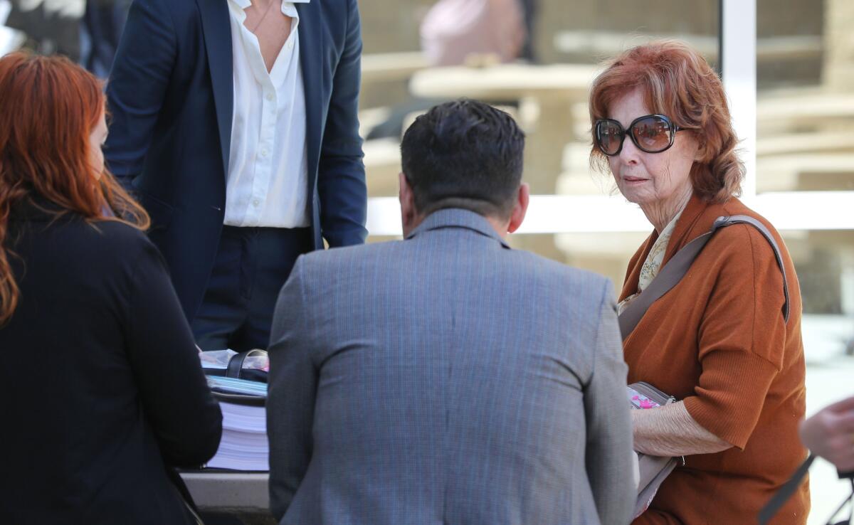 Jane Dorotik, in sunglasses at right, meets with her extensive legal team outside the Vista Courthouse at lunchtime in 2021.