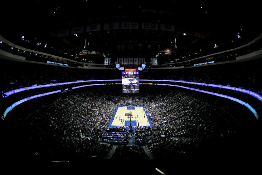 Fans watch during the second half of an NBA basketball game between the Philadelphia 76ers and the Detroit Pistons, Wednesday, March 11, 2020, in Philadelphia. (AP Photo/Matt Slocum)