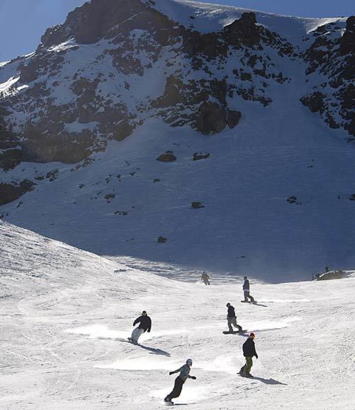 Snowboarders take on the slopes at Mammoth.