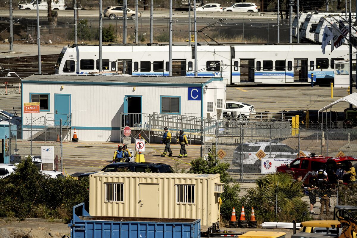 Emergency personnel at a light rail yard 