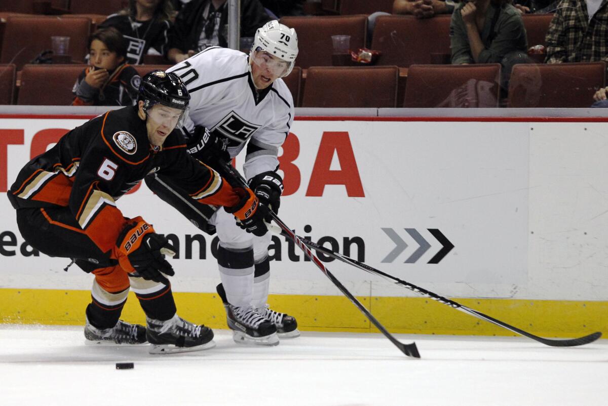 Ducks defenseman Ben Lovejoy, left, and Kings left wing Tanner Pearson vie for the puck Sunday night.