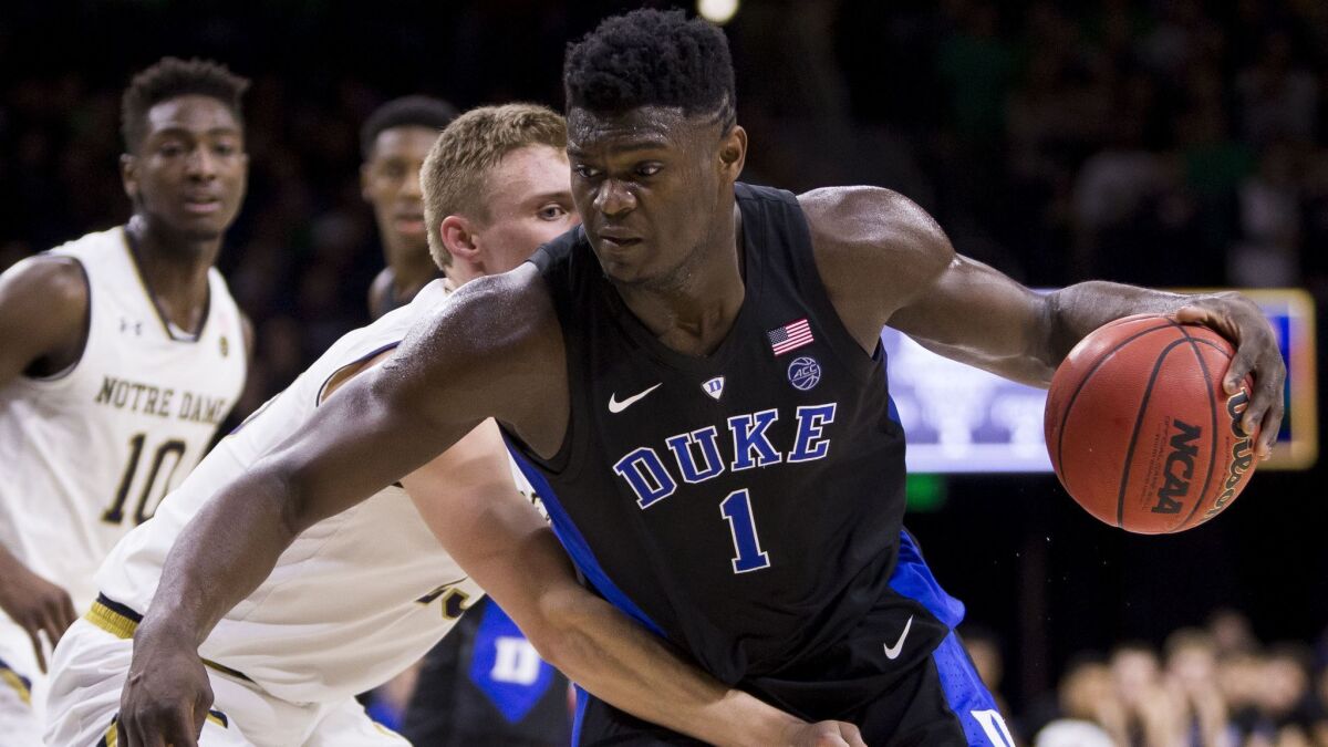 Duke's Zion Williamson (1) is defended by Notre Dame's Dane Goodwin (23) during the first half.