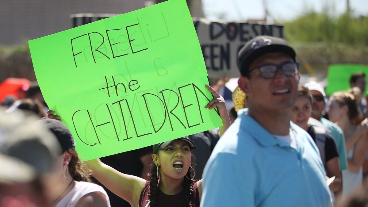 Bianey Reyes. cemter. and others protest the separation of children from their parents in front of the El Paso Processing Center at the Mexican border on June 19.