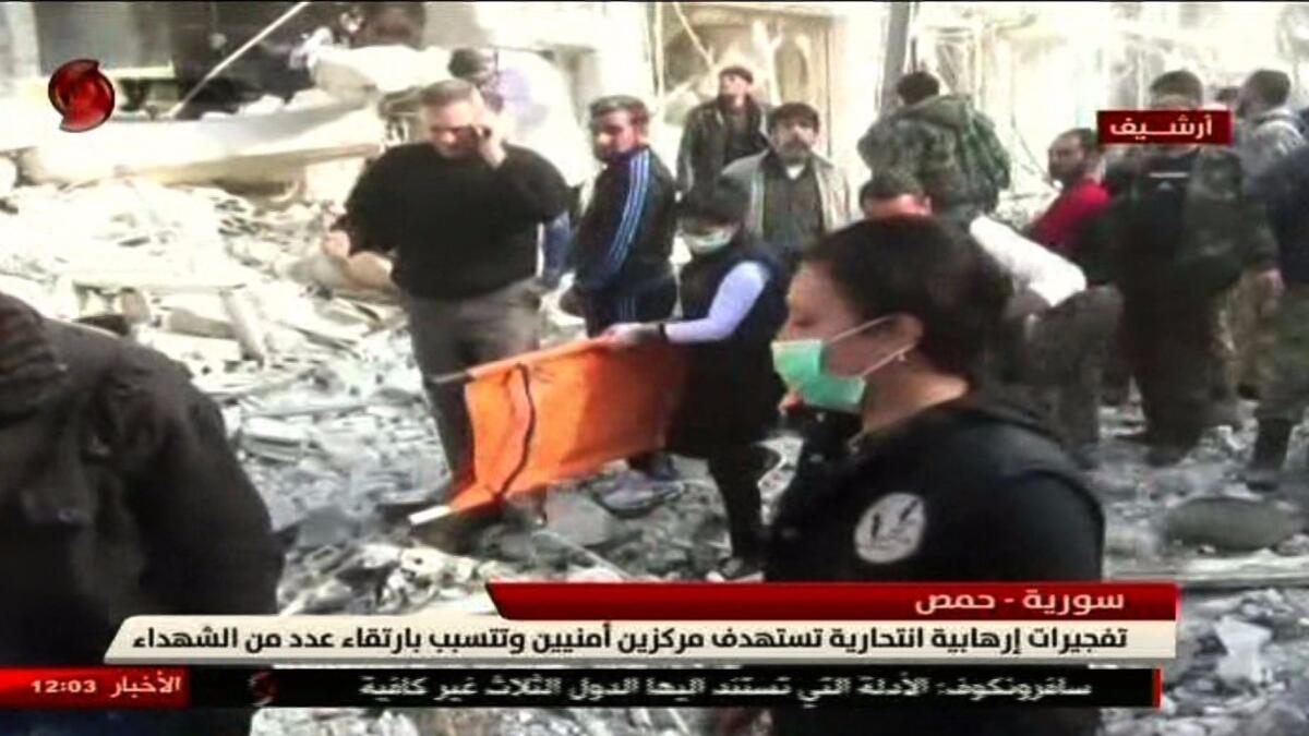 An image from Al Ikhbariya Al Souriya TV shows the aftermath of Saturday's attacks in Homs, Syria.