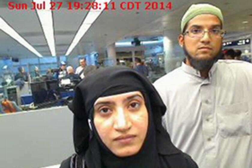 A photo from U.S. Customs and Border Protection shows Tashfeen Malik, left, and Syed Farook as they passed through O'Hare International Airport in July 2014.