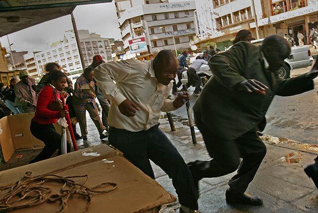 January 16, 2008: Protesters flee as Kenyan police use tear gas and fire live rounds to disperse a rally in the capital, Nairobi. Thousands of Raila Odinga's supporters clashed with police in several cities, defying a ban on protests.