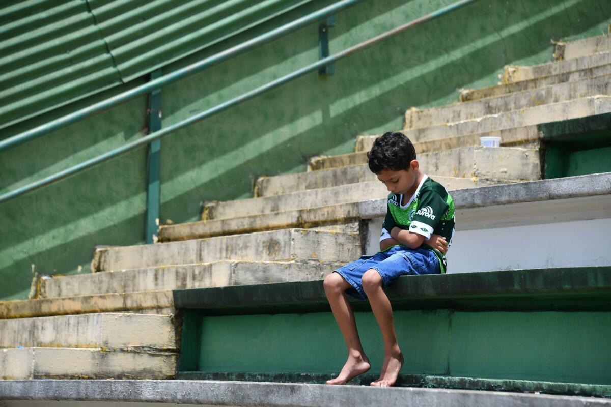 A boy sits alone on the stands during a tribute to the players of Brazilian team Chapecoense Real who were killed in a plane accident in the Colombian mountains, at the club's Arena Conda stadium in Chapeco, in the southern Brazilian state of Santa Catarina, on November 29, 2016. Players of the Chapecoense were among 81 people on board the doomed flight that crashed into mountains in northwestern Colombia, in which officials said just six people were thought to have survived, including three of the players. Chapecoense had risen from obscurity to make it to the Copa Sudamericana finals scheduled for Wednesday against Atletico Nacional of Colombia. / AFP PHOTO / Nelson ALMEIDANELSON ALMEIDA/AFP/Getty Images ** OUTS - ELSENT, FPG, CM - OUTS * NM, PH, VA if sourced by CT, LA or MoD **
