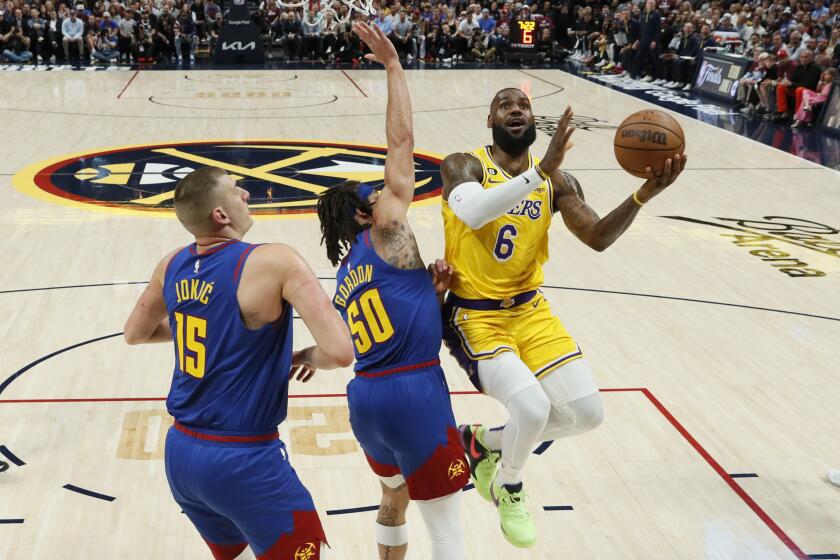 Denver, CO, Tuesday, May 16, 2023 - Los Angeles Lakers forward LeBron James (6) drives to the basket against Denver Nuggets forward Aaron Gordon (50) and Nikola Jokic during first half action in game one of the NBA Western Conference Finals at Ball Arena. (Robert Gauthier/Los Angeles Times)