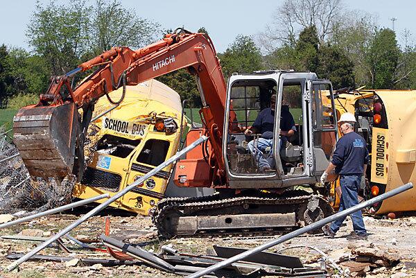 Workers clear debris from tornado-damaged Page Middle School in Gloucester, Va.
