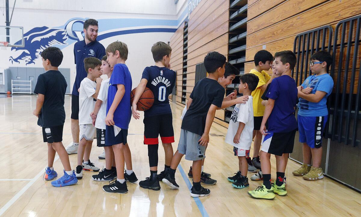 Children in the youngest group line up for a pass-and-shoot drill at the Coach Z Basketball Camp at Crescenta Valley High School on Monday, July 22, 2019. Coach Shawn Zargarian coordinated basketball drills with helping coaches to keep about 50 youth basketball enthusiasts busy.