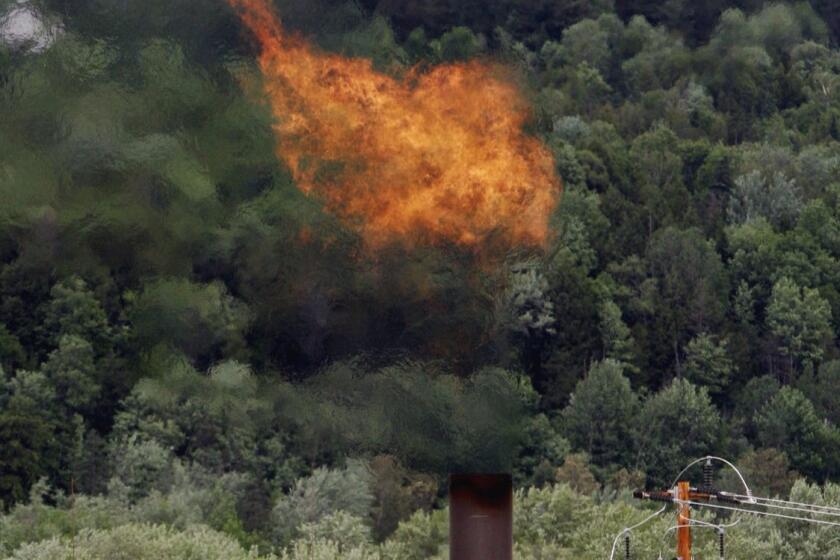 FILE - In this June 15, 2005 file photo, flames from methane burning at the landfill in Coventry, Vt. The Trump administration is delaying two Obama-era regulations aimed at restricting harmful methane emissions from oil and gas production. (AP Photo/Toby Talbot, File)