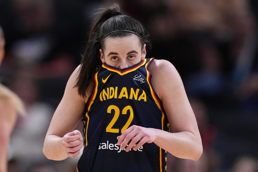 Indiana Fever guard Caitlin Clark wipes her face after hitting a shot and being fouled by the Atlanta Dream during the first half of a preseason WNBA basketball game in Indianapolis, Thursday, May 9, 2024. (AP Photo/Darron Cummings)