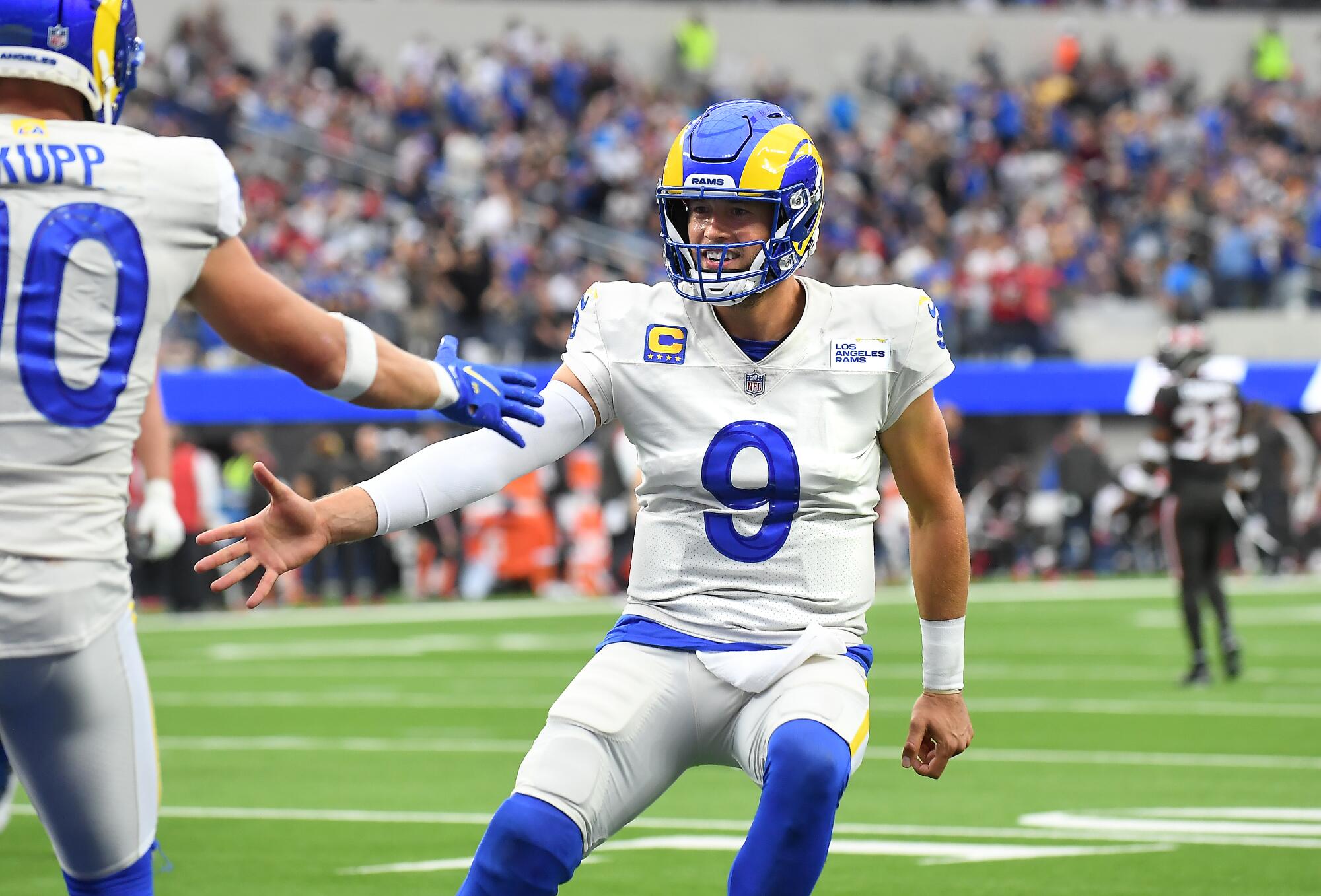 Rams quarterback Matthew Stafford congratulates Cooper Kupp (10) after the two connected on a touchdown pass.