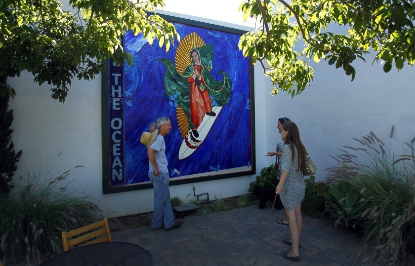 Artist Mark Patterson created the Surfing Madonna in 2011. Now the artwork might be removed from its public viewing space along Encinitas Boulevard and placed into storage as a result of a dispute between the Surfing Madonna Oceans Project and the city of Encinitas.