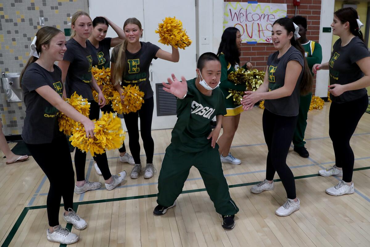 Edison High Special Abilities Cluster cheerleader Kyle Hoang, center, dances with members of the varsity cheerleading squad.