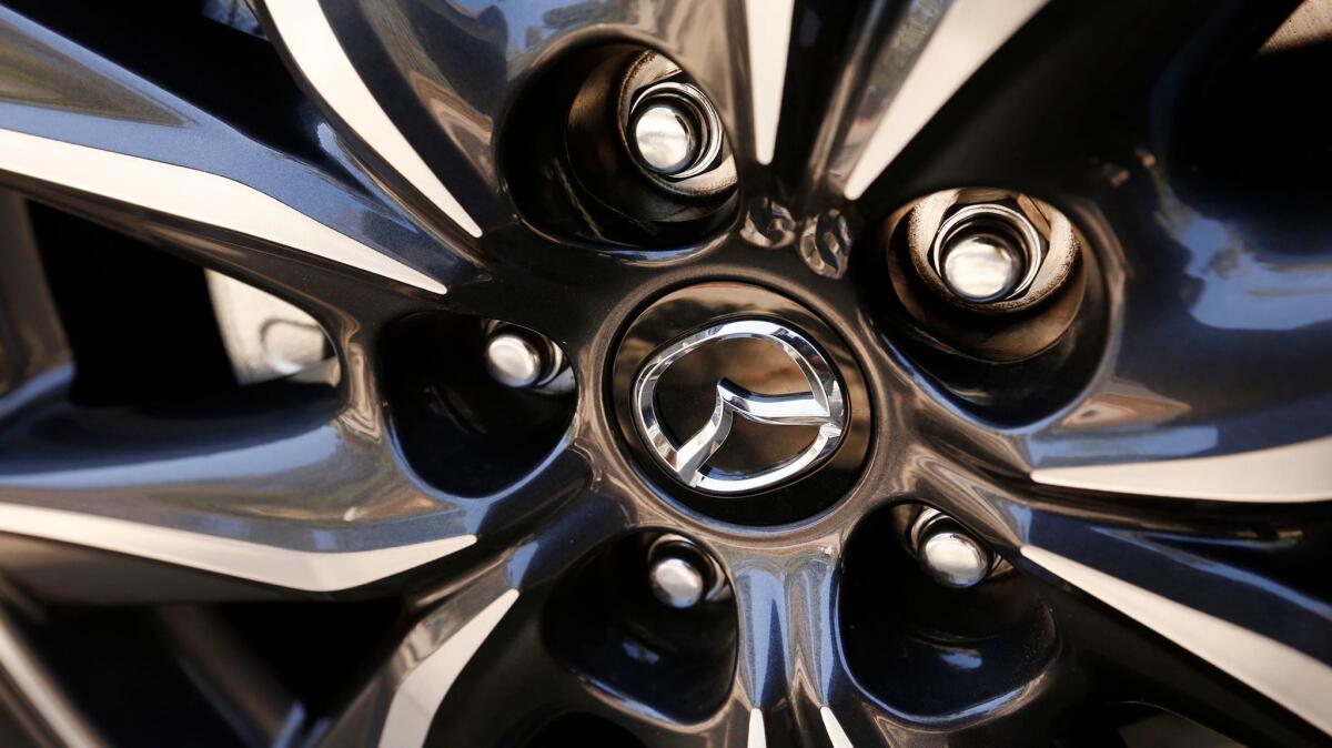 The Mazda logo is displayed on a hubcap.