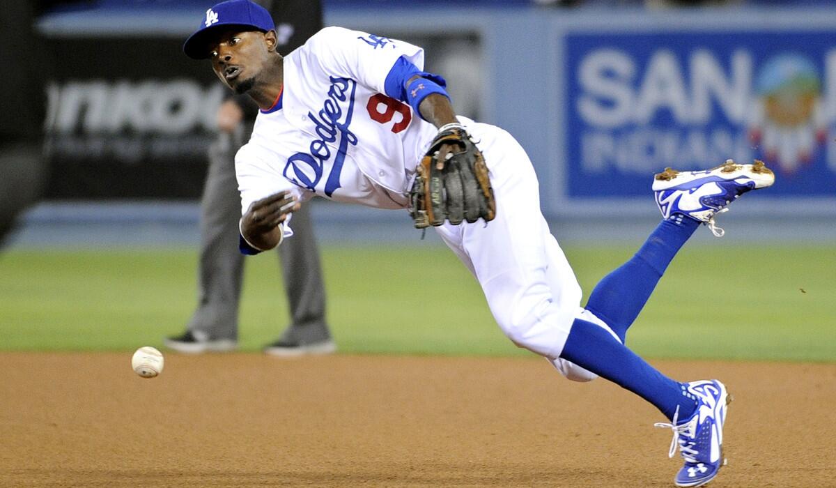 Dodgers second baseman Dee Gordon makes a throw to first base after fielding a grounder by the Giants' Brandon Belt in the fourth inning. First baseman Adrian Gonzalez was charged with an error when he couldn't make the catch.