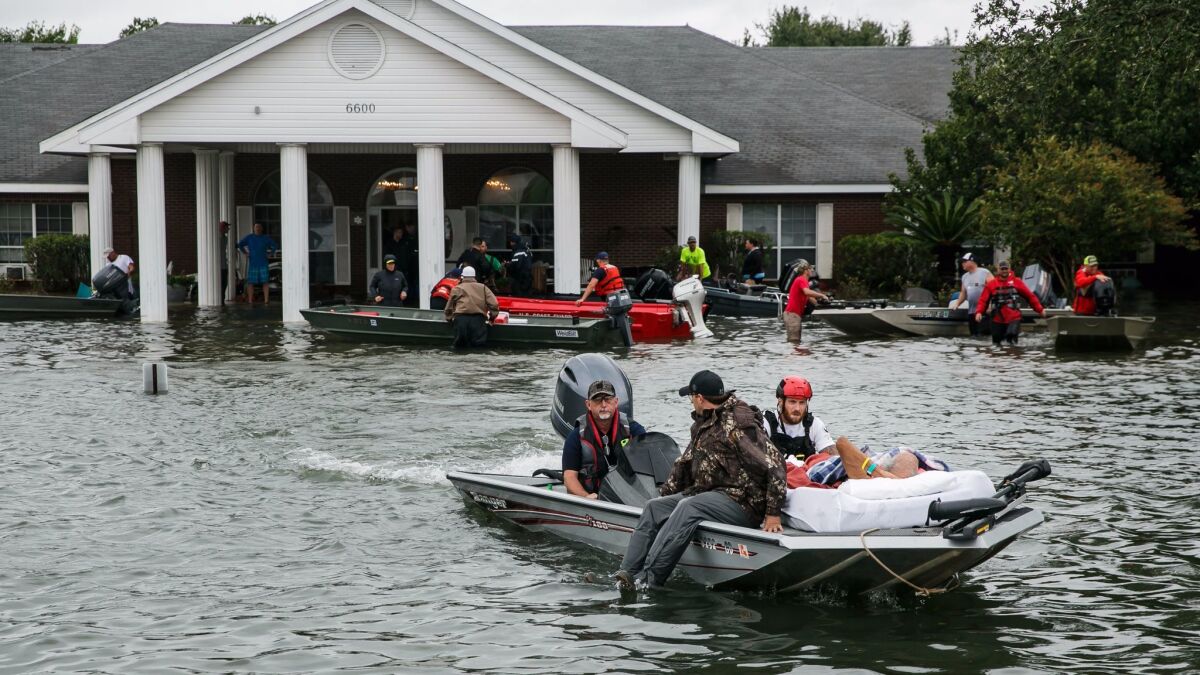 Volunteers rescue residents from the Cypress Glen nursing home in Port Arthur, Texas, on Aug. 30, 2017.