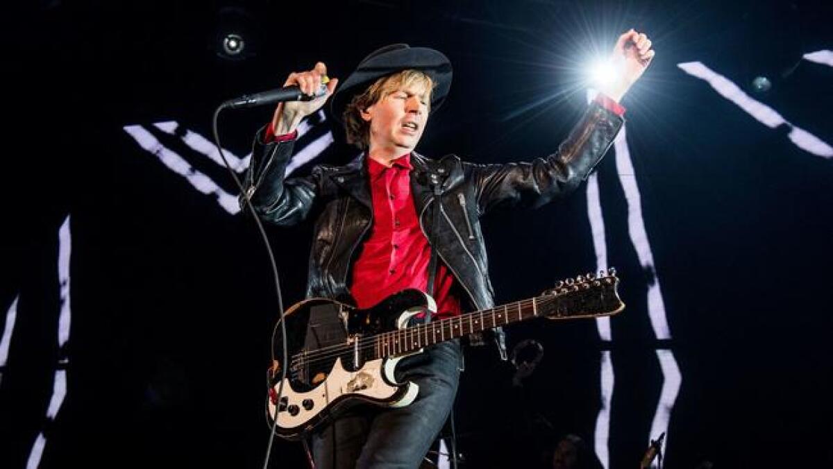 Beck performs Sunday during KROQ's Almost Acoustic Christmas concert at the Forum.