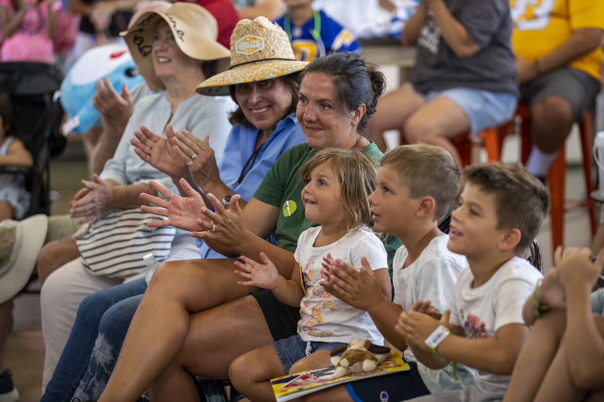 Audience members react to a magic show performance by Frank Thurston at the Orange County Fair on Thursday.