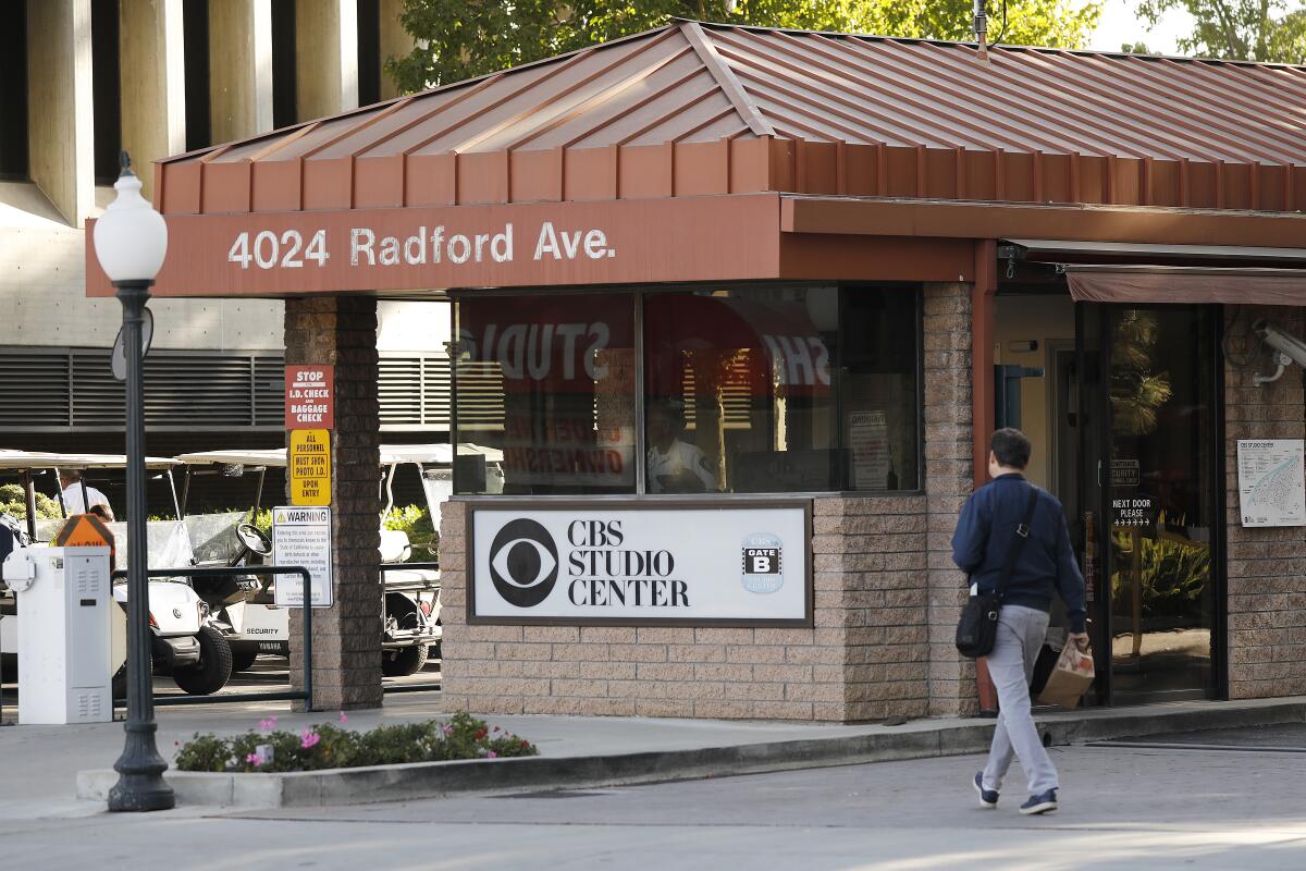 A person walks by the CBS Studio Center entrance.