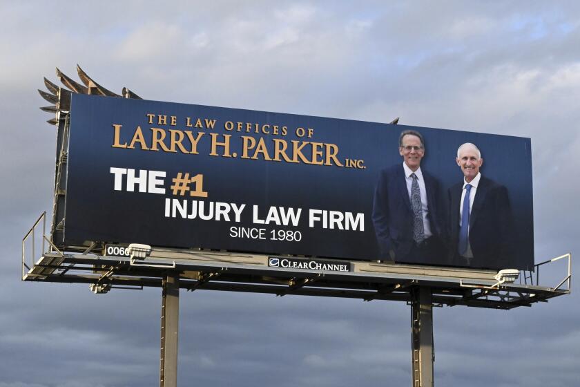 The Law Offices of Larry H. Parker billboard along the Interstate 710 North freeway amid the coronavirus COVID-19 global pandemic, Monday, March 23, 2020, in Los Angeles. (Kirby Lee via AP)
