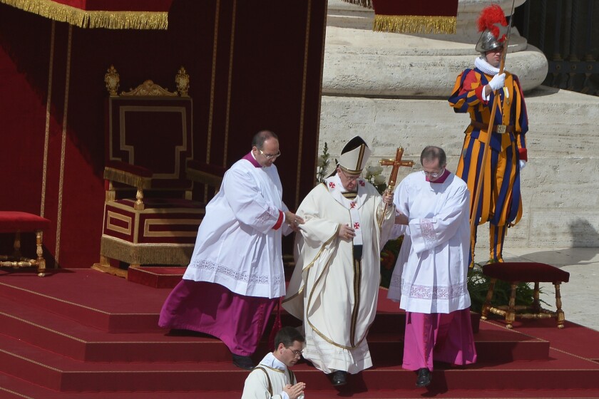 Pope Francis, center, walks to the altar during his grandiose inauguration mass at St Peter's square at the Vatican.