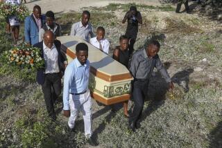 Relatives carry the coffin of Jean Louis Jeune Gracien, who was killed during an attack by armed gangs, at his funeral in Pont-Sonde, Haiti, Tuesday, Oct. 8, 2024. (AP Photo/Odelyn Joseph)