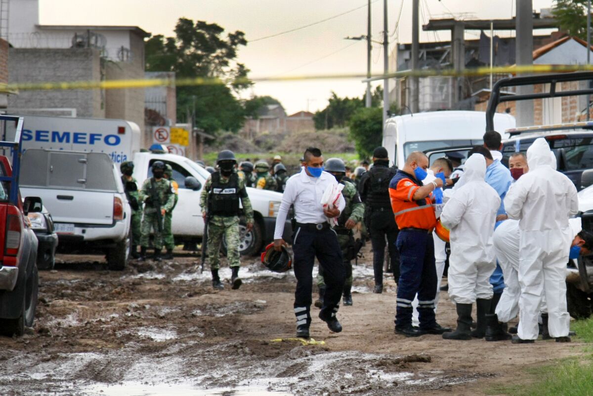 Forensic service personnel prepare to enter a drug rehabilitation center in Irapuato, Mexico.
